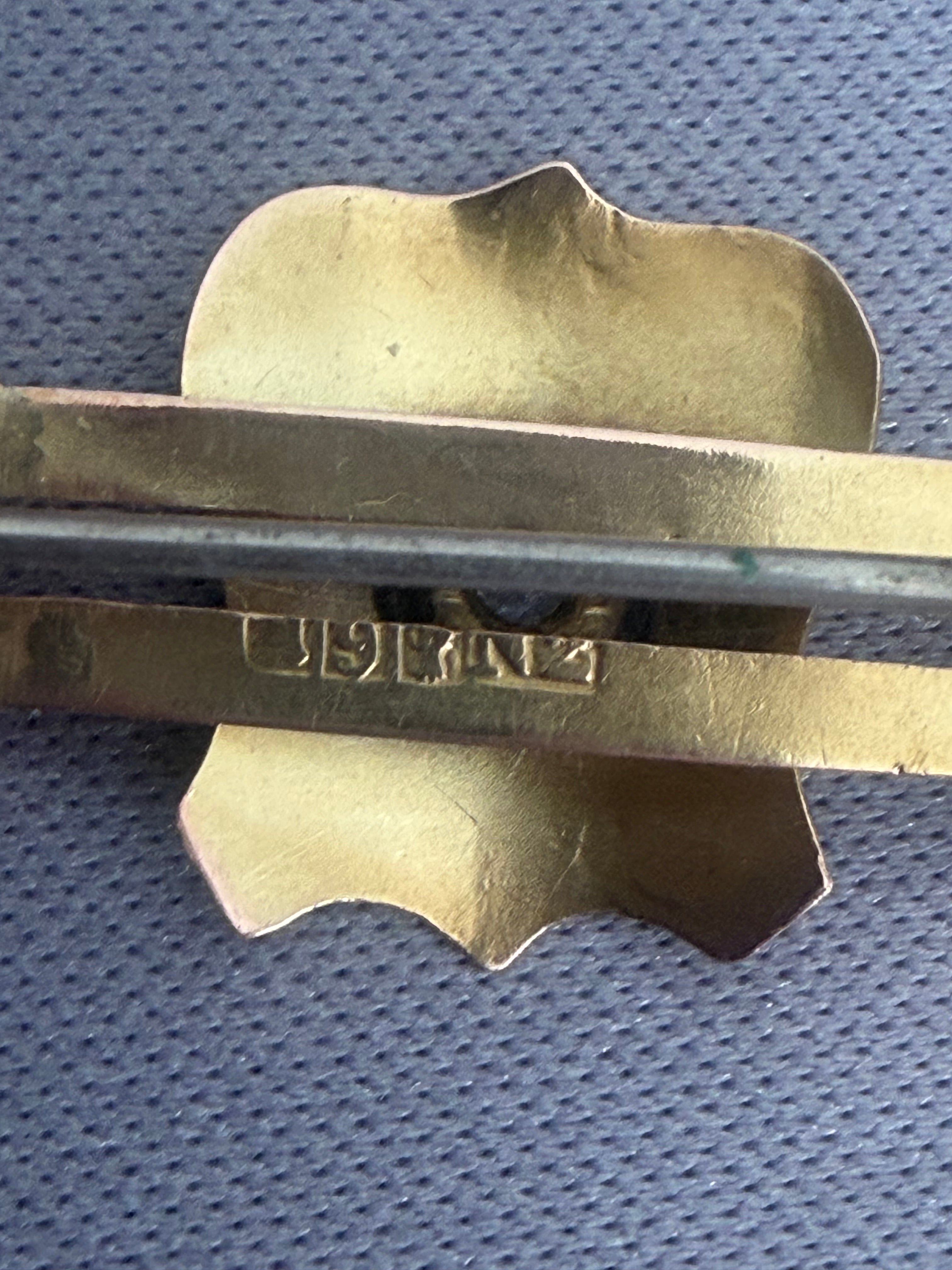Antique Australian Gold brooch with shield design and chain.  Rear shows Victoria Australia Guild Stamps 9CT, Aronson Co and NZ designation for export