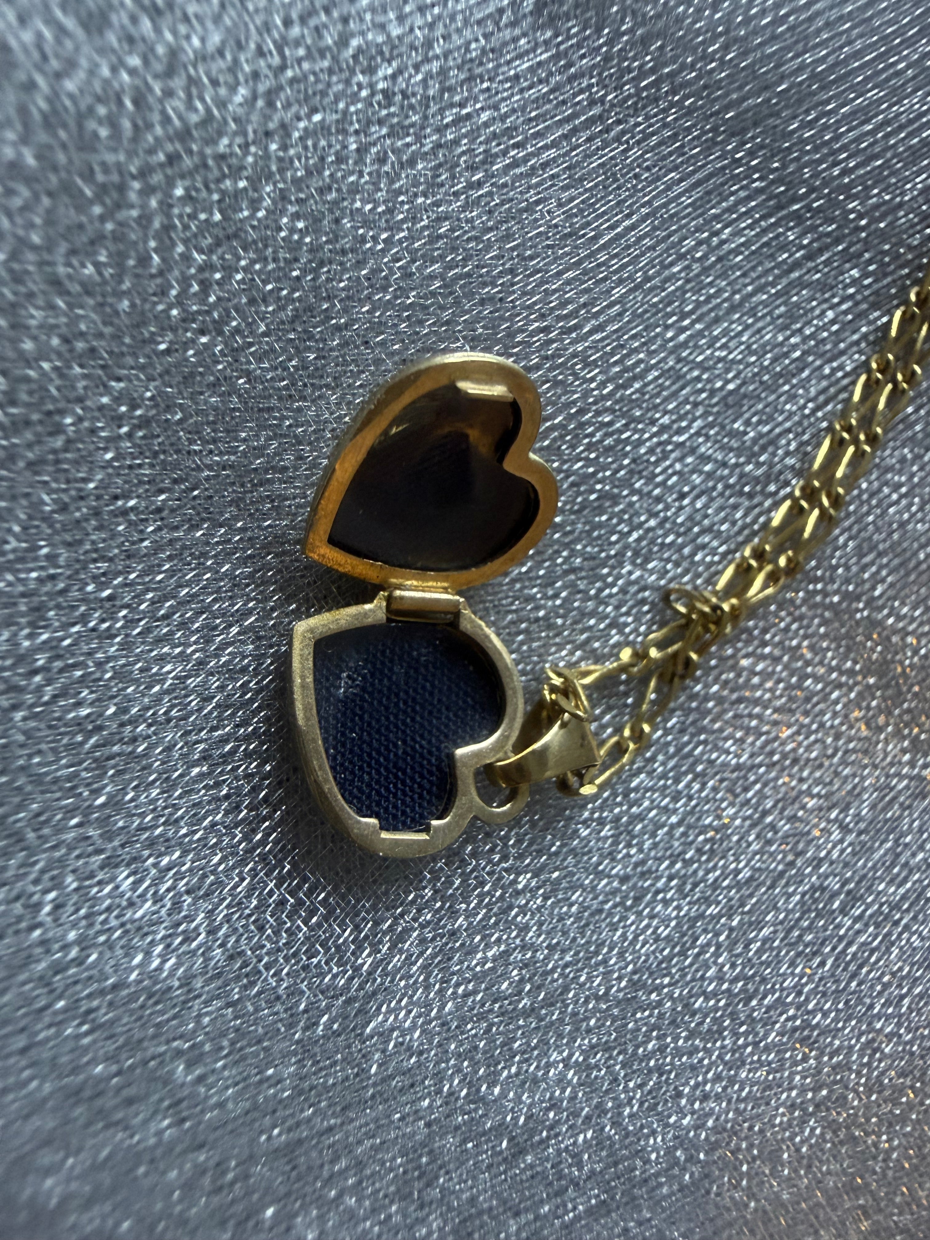 Vintage 9ct gold heart locket open — interior compartment for photo or keepsake