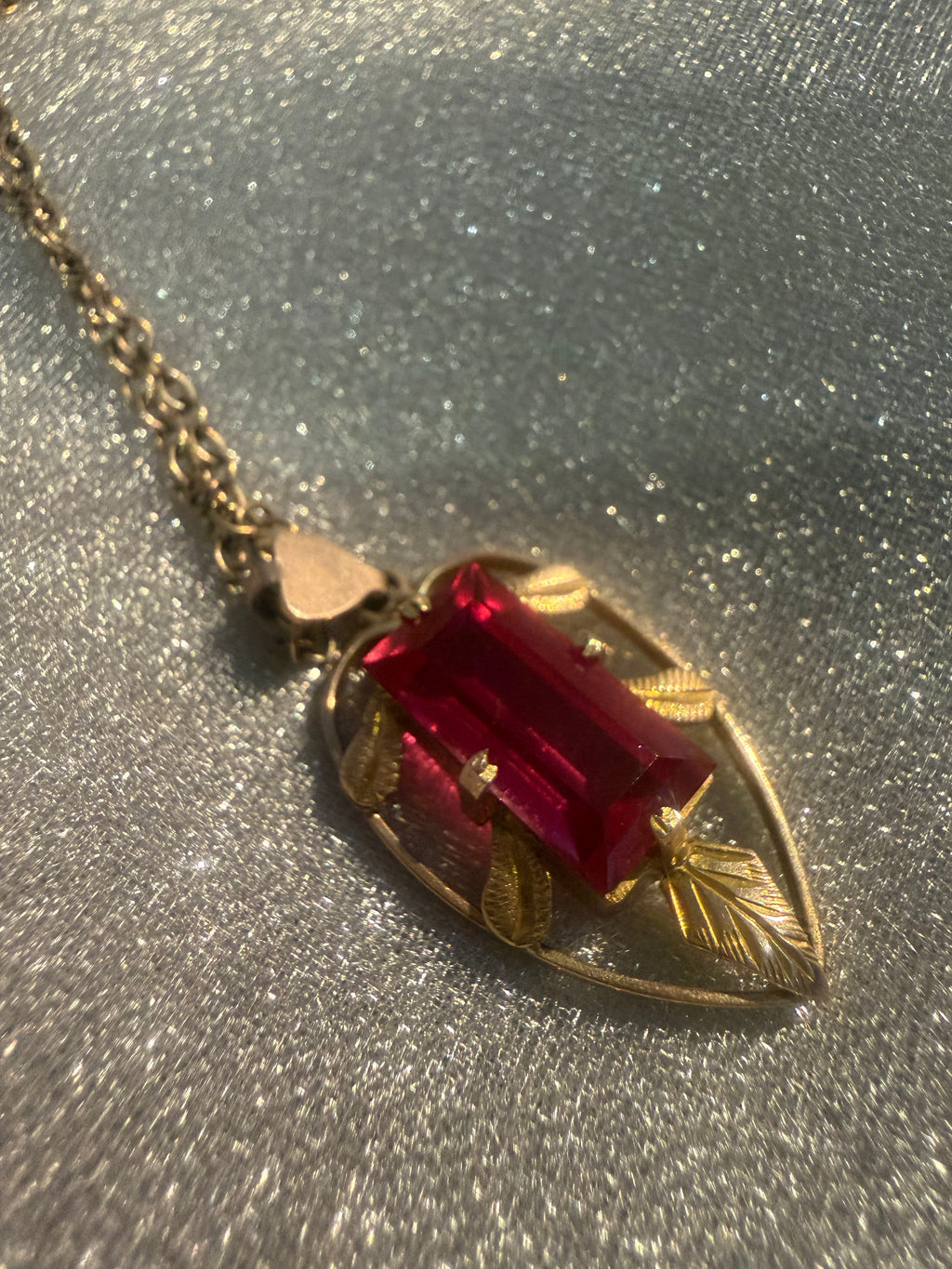 Close-up of engraved leaf motif on vintage 9ct gold Australian Lustre pendant