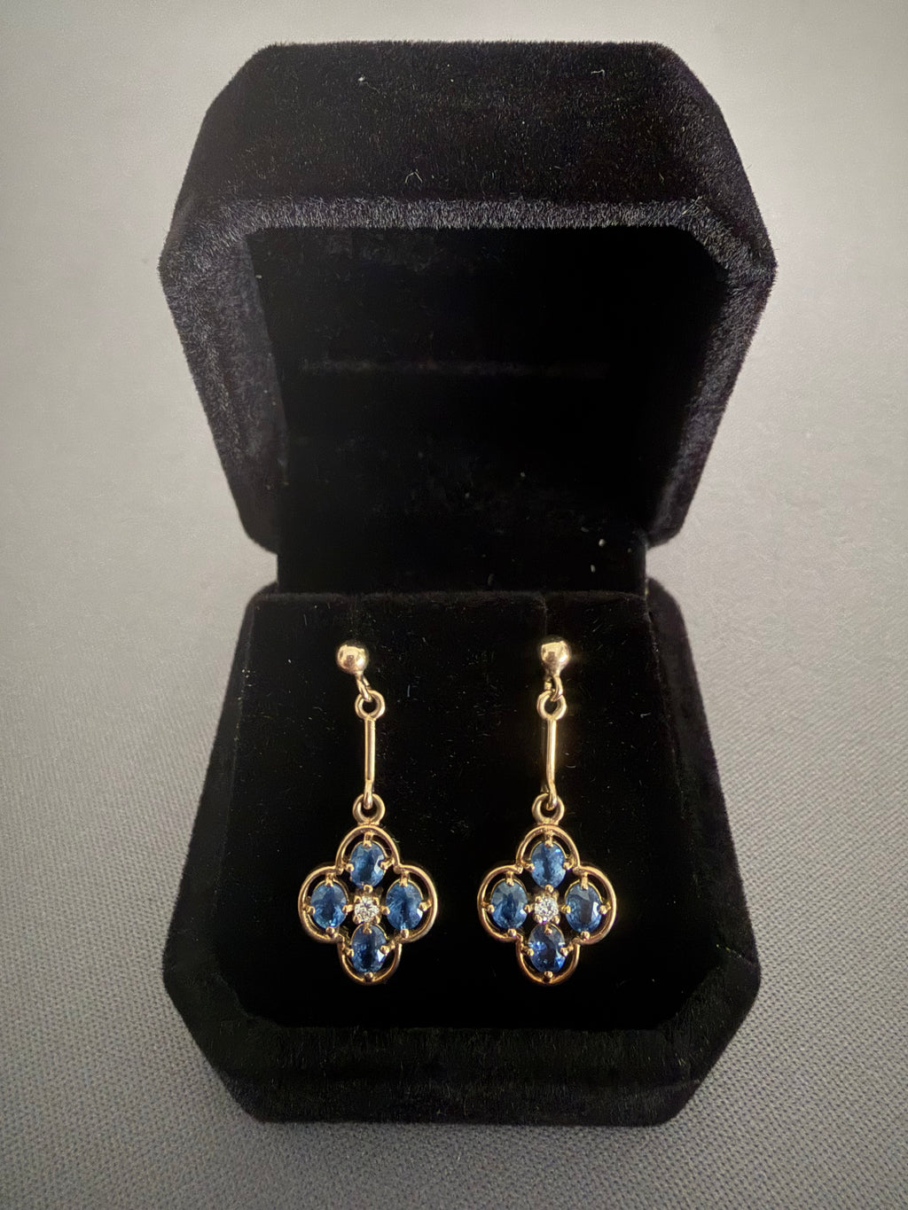 Vintage 9ct gold drop earrings with blue oval sapphires in a clover quatrefoil design and central diamond accent